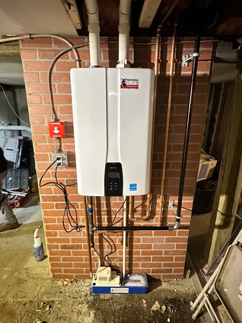 Same Navien tankless install, powered up and running at 125°F — condensate neutralizer, gas emergency shut-off, and dedicated circuit all code-compliant.