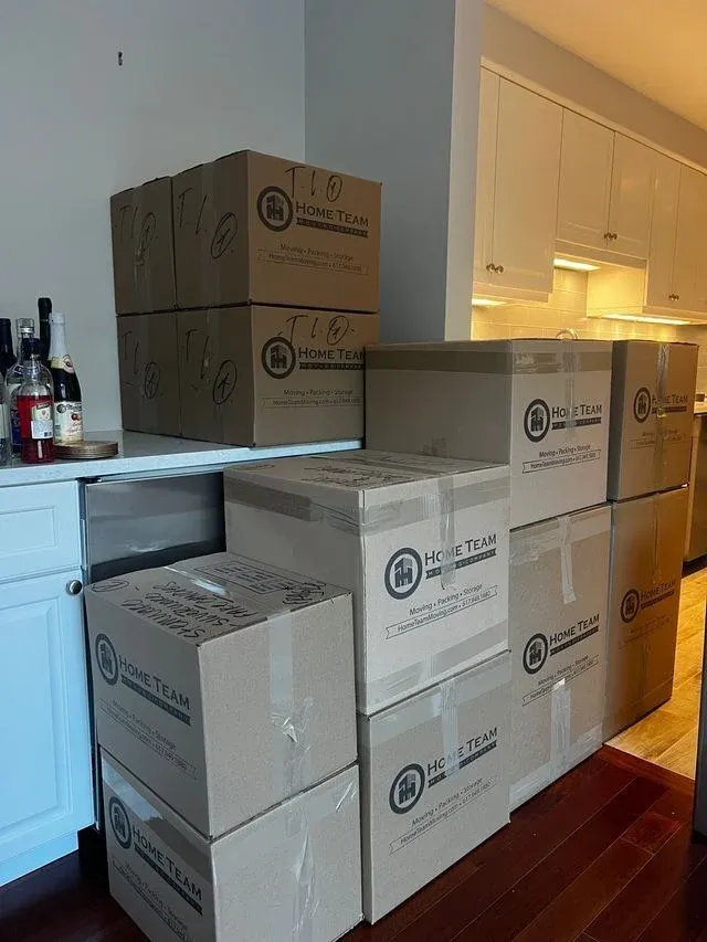 Home Team-branded cartons packed and labelled in a kitchen
