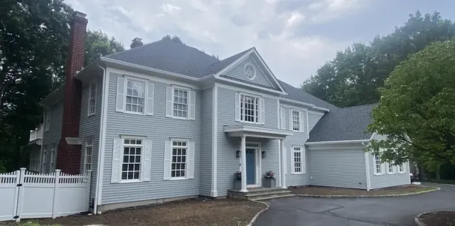 Roof replacement and new gutters on a hip-roof home in Weston, CT