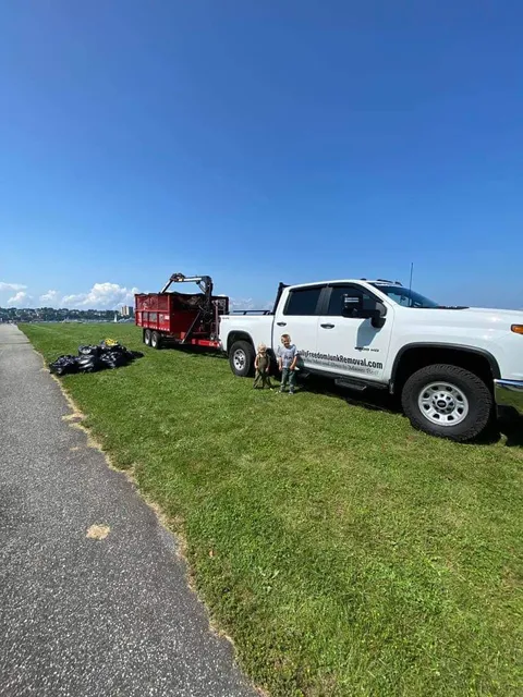 Image of the Finally Freedom Junk Removal truck and trailer