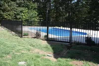 Ornamental pool-code fence around an in-ground pool