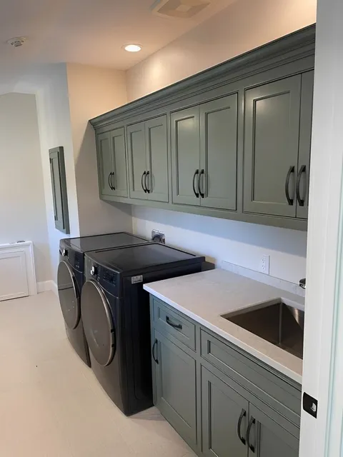 A Tidy Laundry Room Featuring A Modern Washer And Dryer, Organized For Efficient Laundry Tasks.