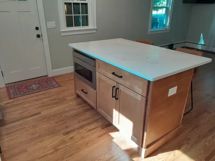 A kitchen with a large island in the middle of the room.