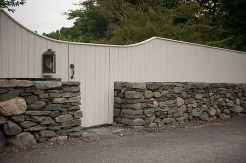 Custom white wooden and stone fence