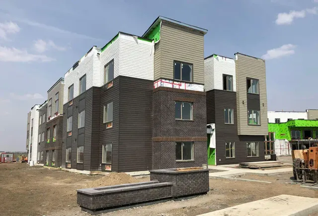 A three-storey multi-family building clad over ThermaSteel panels