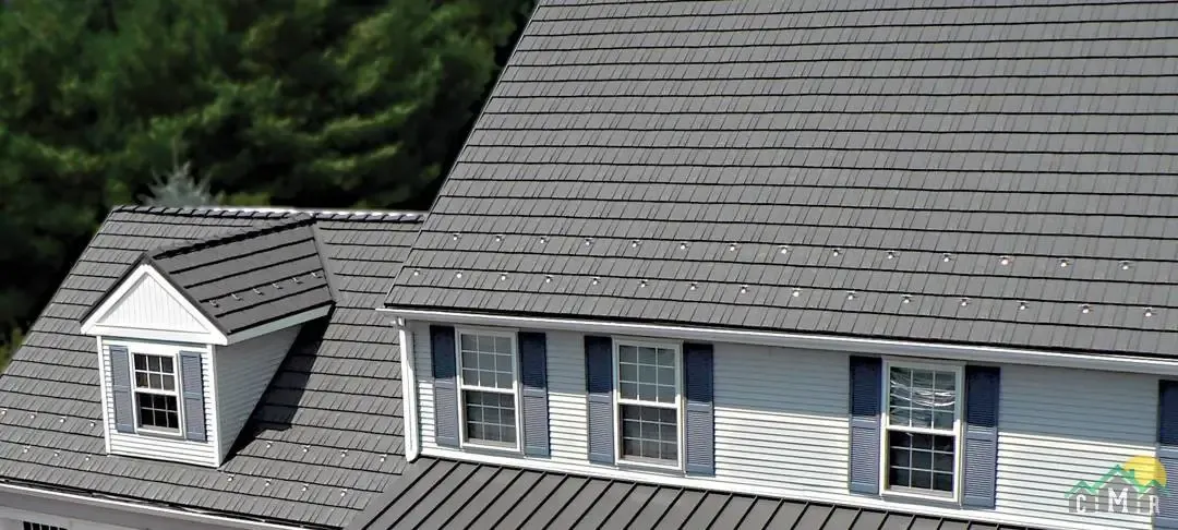 A roof on a house in New Hampshire with rustic shake metal shingles in gray