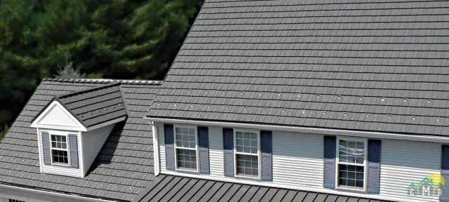 A roof on a house in New Hampshire with rustic shake metal shingles in gray