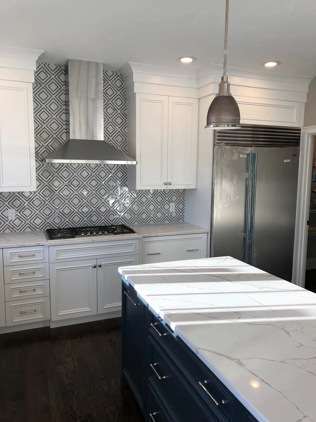 Marble kitchen with navy island built by Hanna Construction