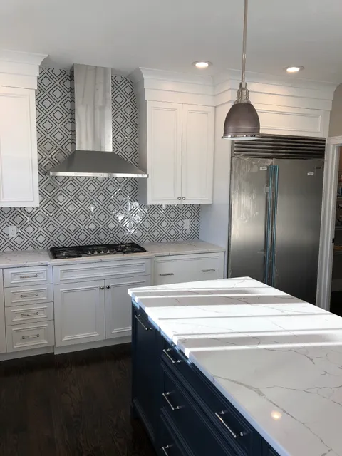 Marble kitchen with navy island built by Hanna Construction