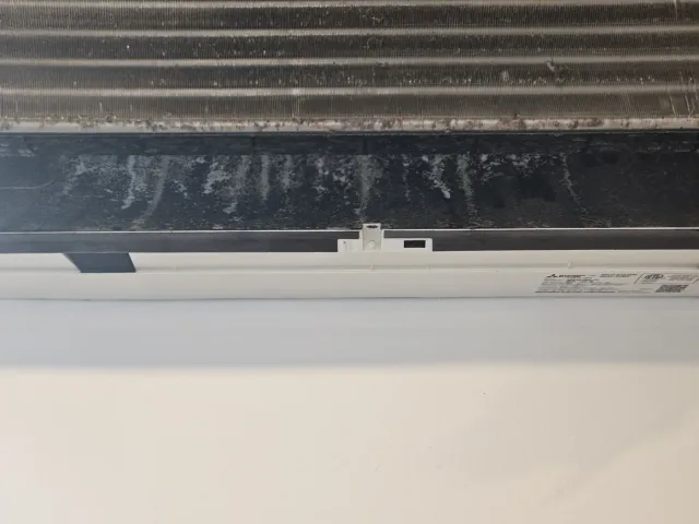 Mitsubishi mini-split coil and blower wheel before cleaning, heavy dust and mold on the wheel