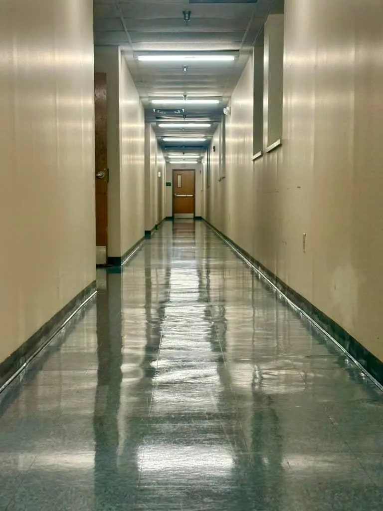 A polished corridor floor in a commercial building after cleaning