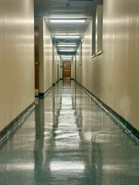 A polished corridor floor in a commercial building after cleaning
