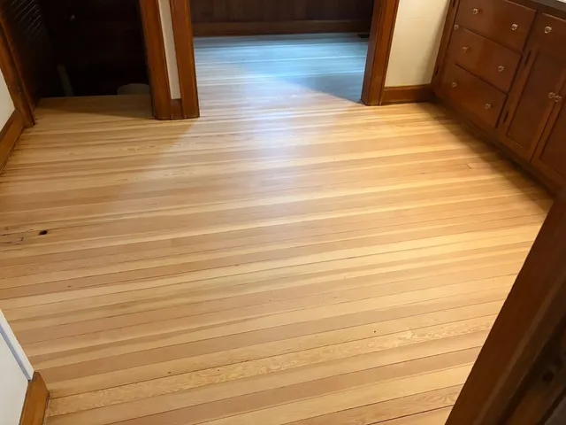 Refinished hardwood floor with built-in cabinetry