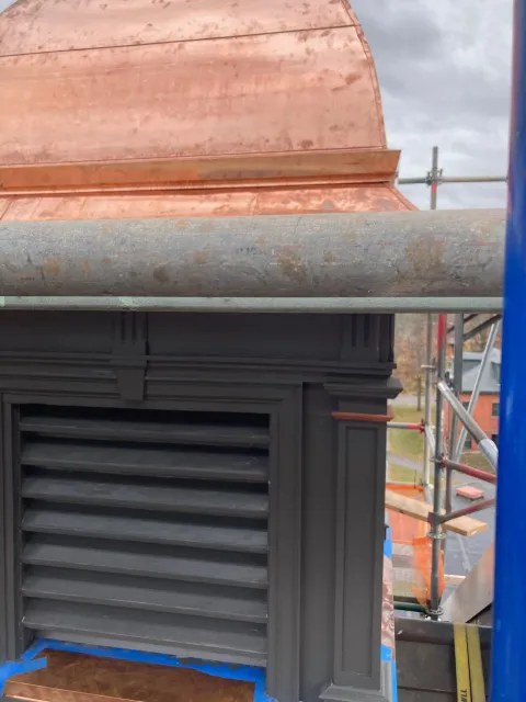 A copper roof is being installed on a building.