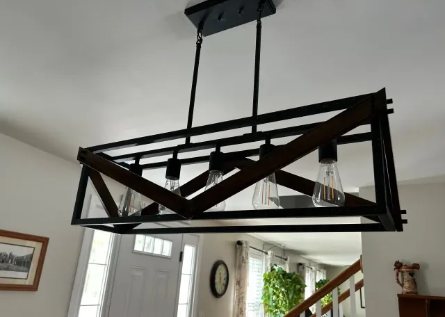 A chandelier is hanging from the ceiling in a living room.