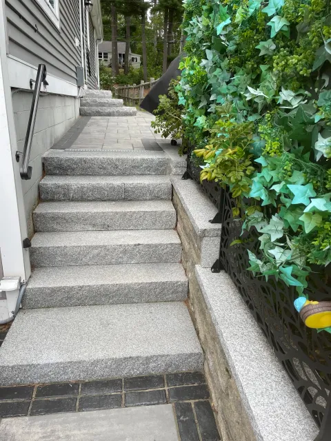 Granite and hand paved walk way with stone wall boarder