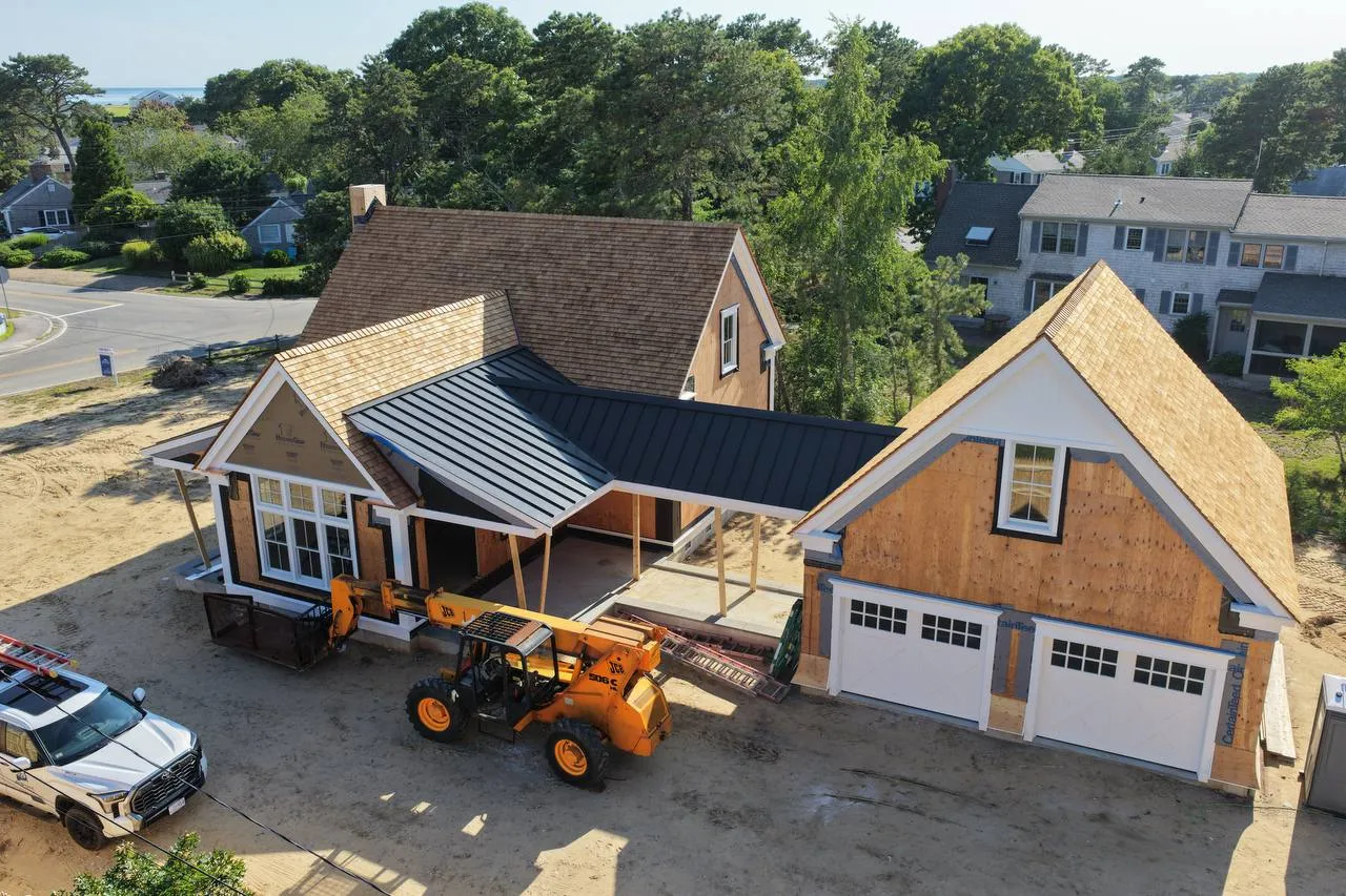 Detached garage with cedar shingle roof and standing seam breezeway roof