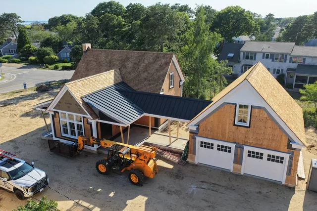 Detached garage with cedar shingle roof and standing seam breezeway roof