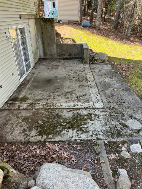 Before and after concrete power washing showing stain removal