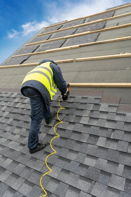 Professional roofer installing premium GAF Timberline HDZ shingles on a residential roof in Southern Maine