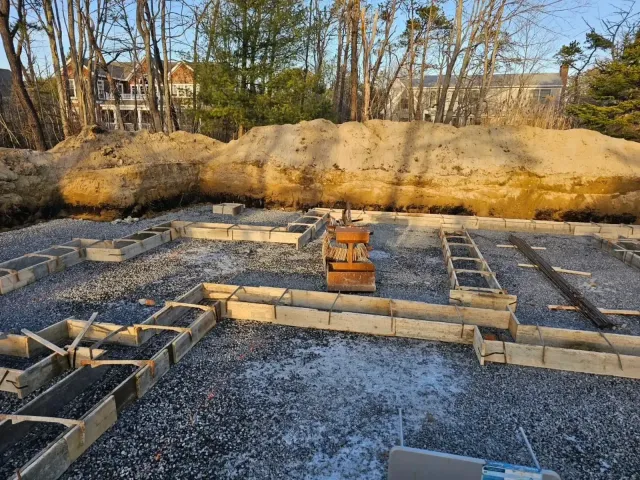 A construction site with a large pile of dirt in the background.