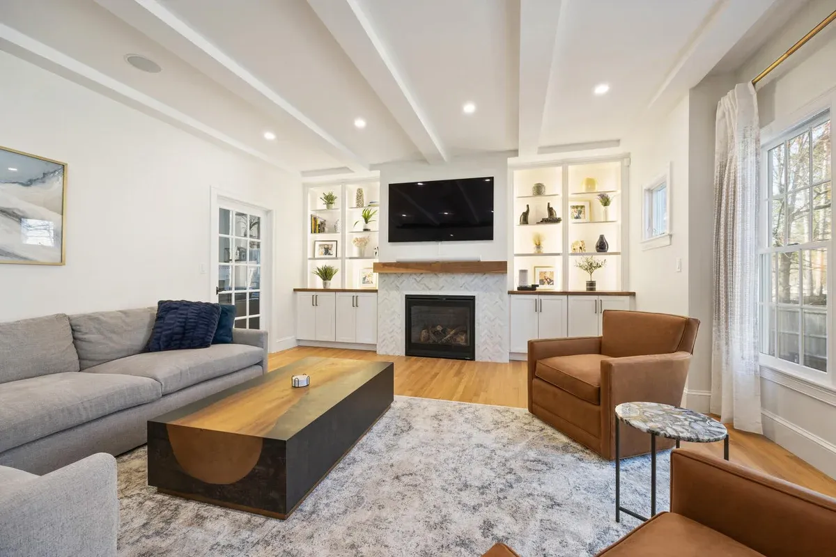 living room remodel with fireplace and integrated shelving by PEGASUS Design-to-Build in Lexington, MA