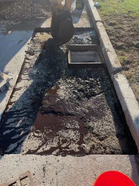 A person is digging a hole in the ground with a shovel.