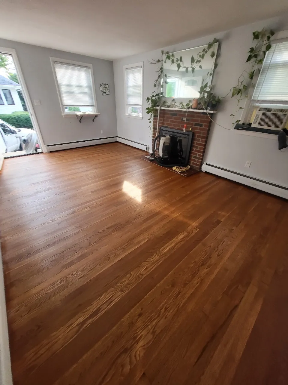 Freshly refinished hardwood floor by H H Flooring