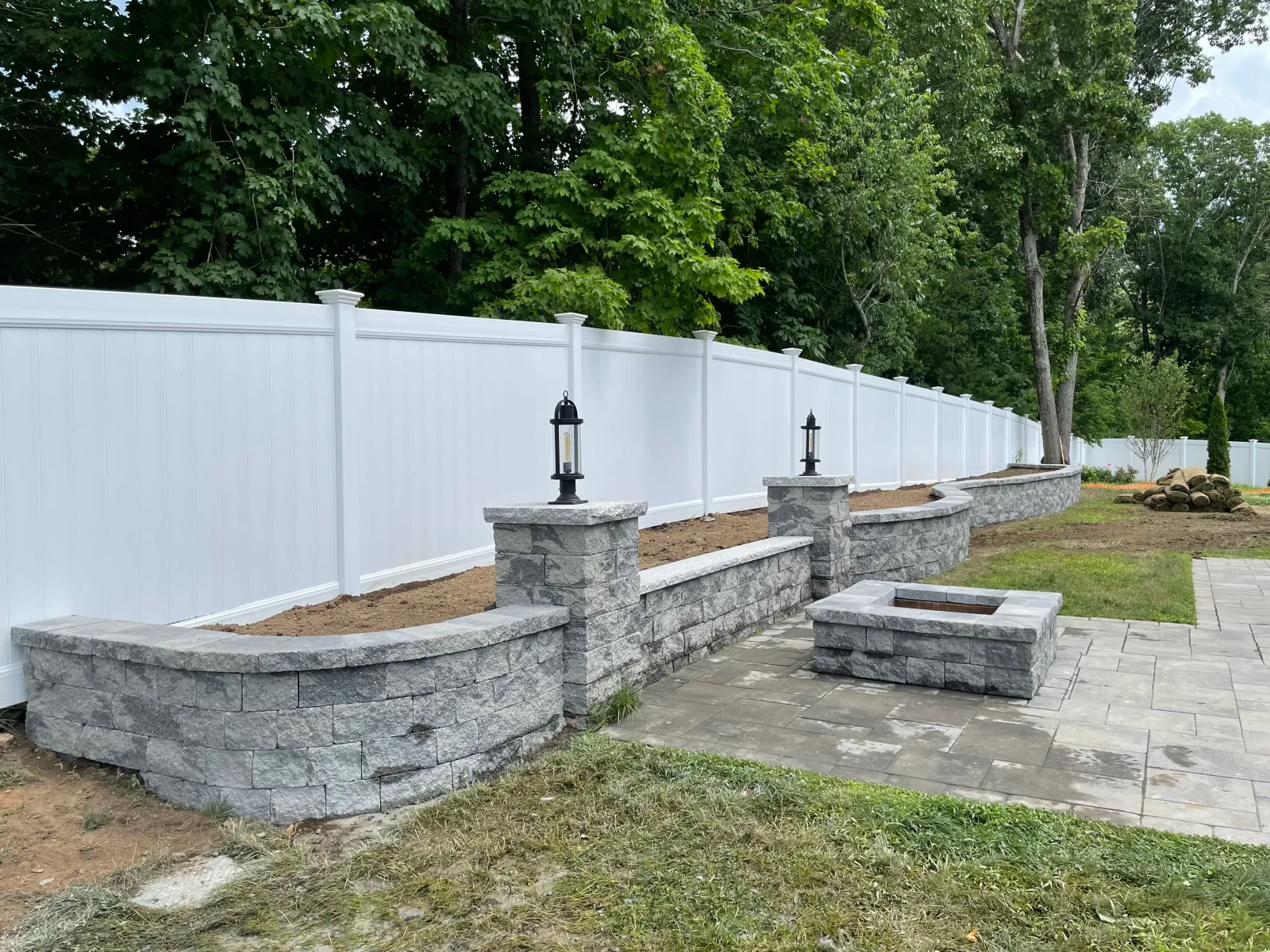 Retaining wall, fire pit and paver patio with new fencing