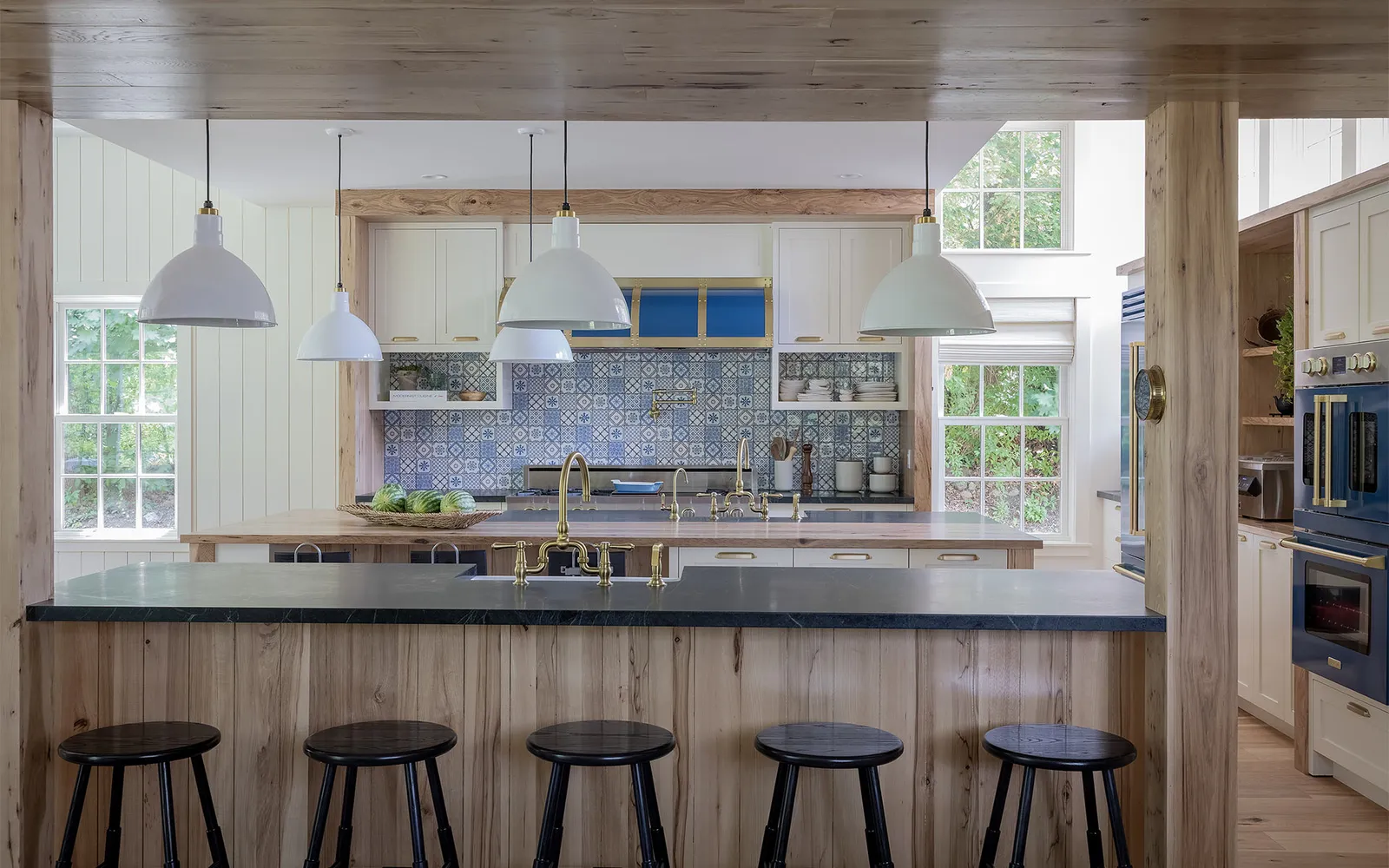 A kitchen with a center island and bar stools
