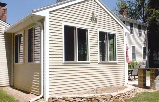 Completed rear addition with new siding and windows
