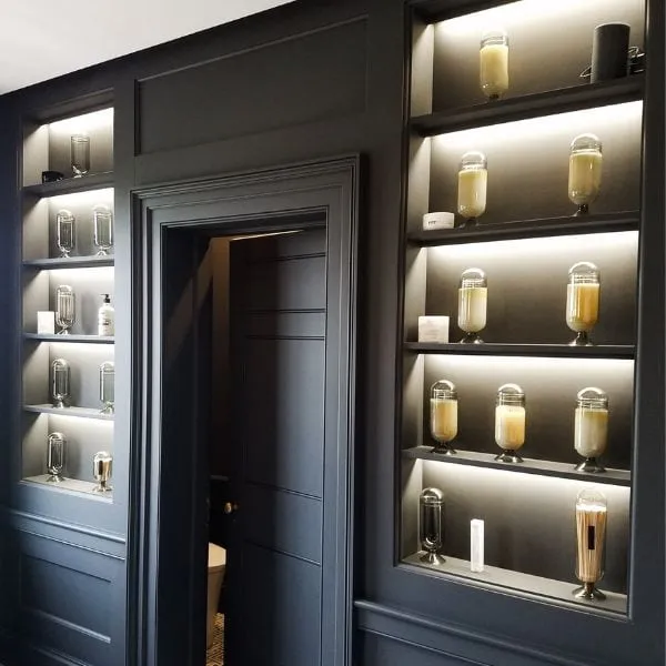 Custom paneling and built-in shelving with integrated LED shelf lighting in a Stratham, NH home remodel