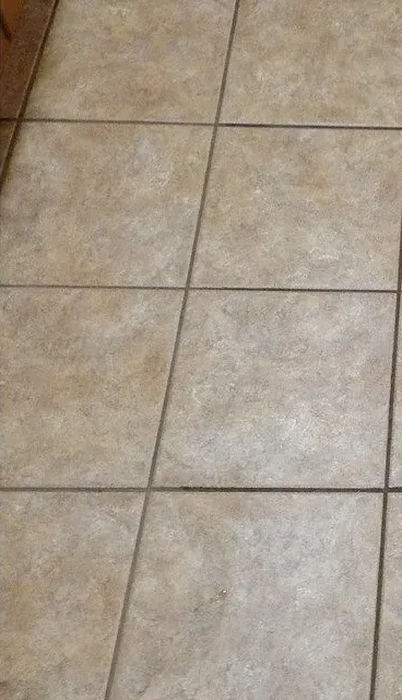 Accessible shower with built-in bench, grab bar, multiple shower heads, and tiled walls/floor.