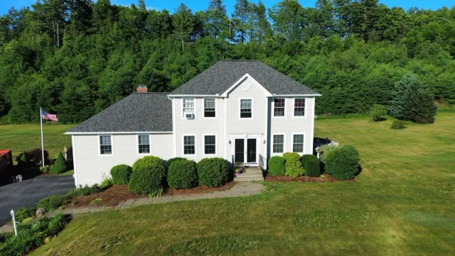 Completed asphalt shingle roof replacement on a two-story home in Oakham, MA