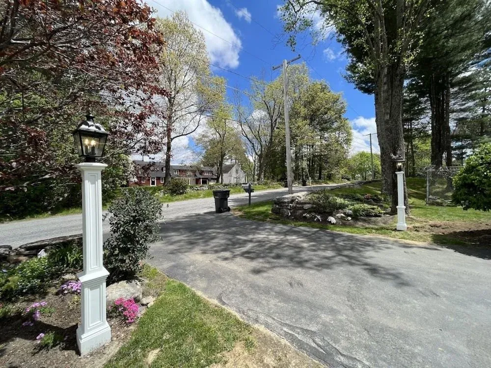 dual light posts installed at the end of a driveway offering an impressive and welcoming entrance to the driveway
