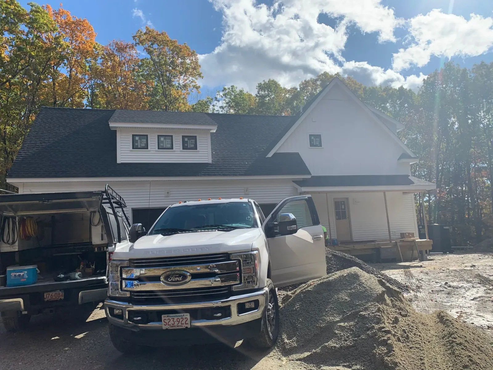 A white truck is parked in front of a house.