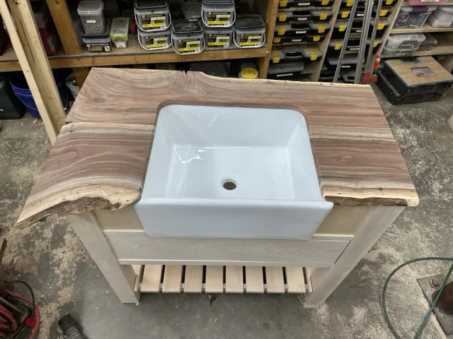 Live-edge walnut top fitted over the sink