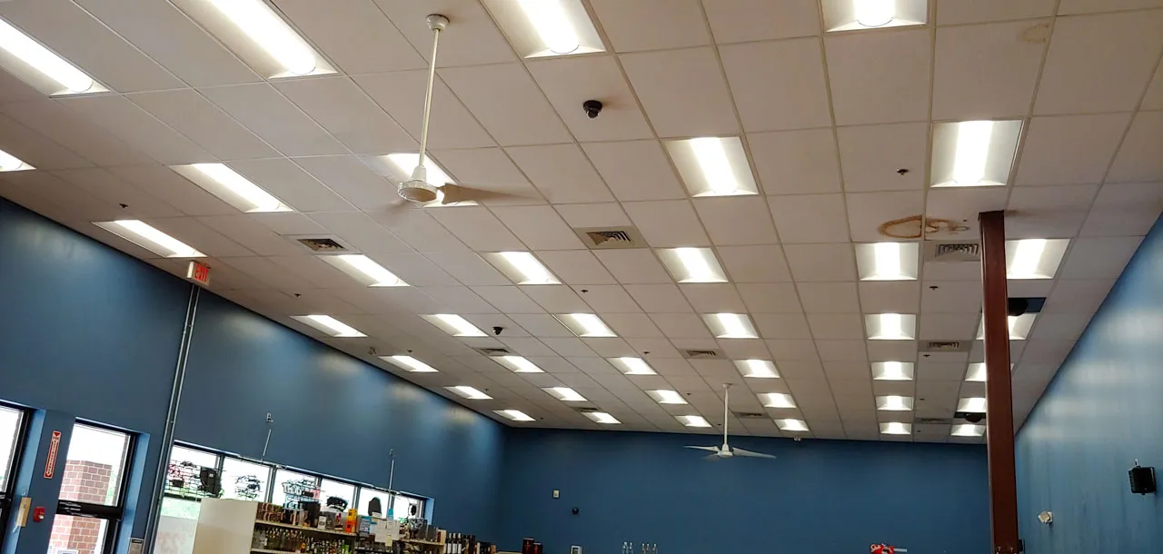 A retail space with bright ceiling lights and ceiling fans, providing efficient lighting and ventilation.
