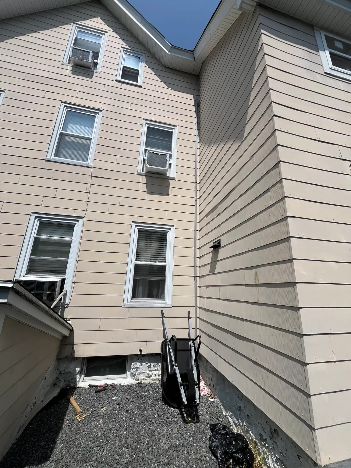 Exterior view of home with third-floor electrical work