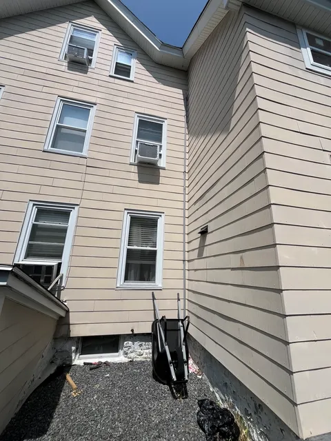 Exterior view of home with third-floor electrical work