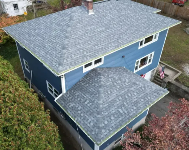 blue house with new gray asphalt roofing HOME