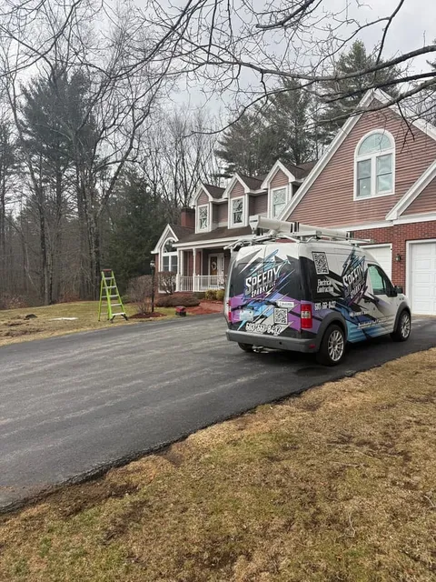 The Speedy Sparky van parked at a New Hampshire home for a scheduled service call.
