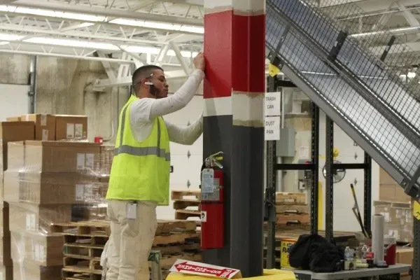 Commercial Painters-ProTEK Painter detailing the metal column of a warehouse-Newton, MA-ProTEK Painters