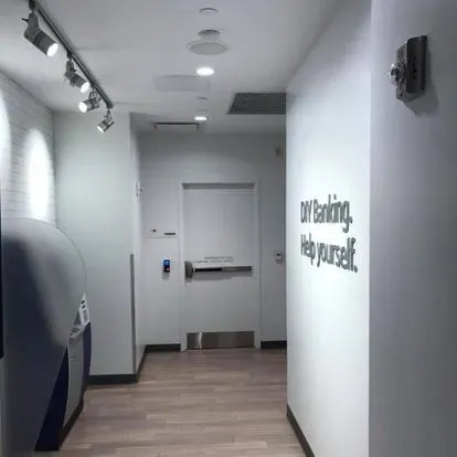 A hallway with a sign on the wall that says