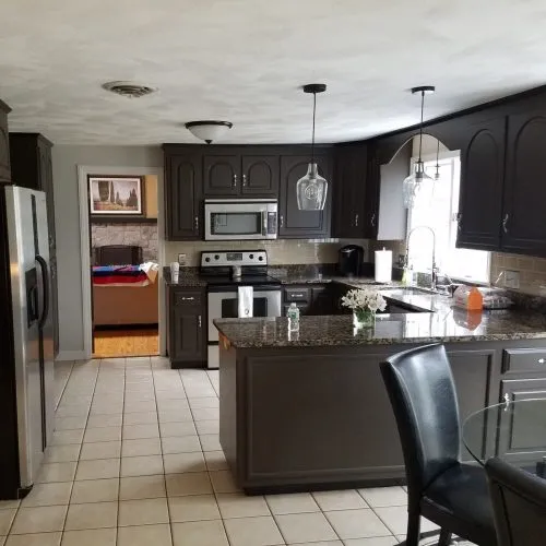 Completed kitchen. Black cabinets and white ceilings