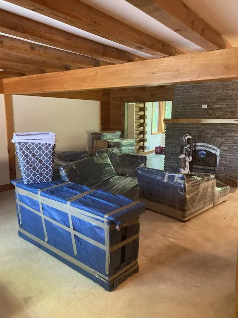 Basement furniture wrapped in padding by Vacationland Moving Company in Maine