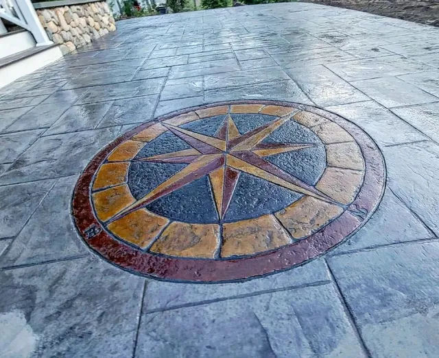 Stamped concrete patio with a hand colored compass rose medallion set into the center