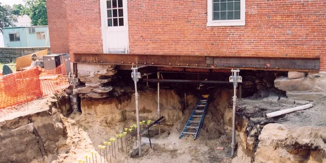 Town hall foundation repair with helical pile underpinnings by Solid Earth Technologies