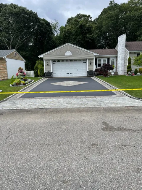 Residential driveway seal coating with decorative paver border