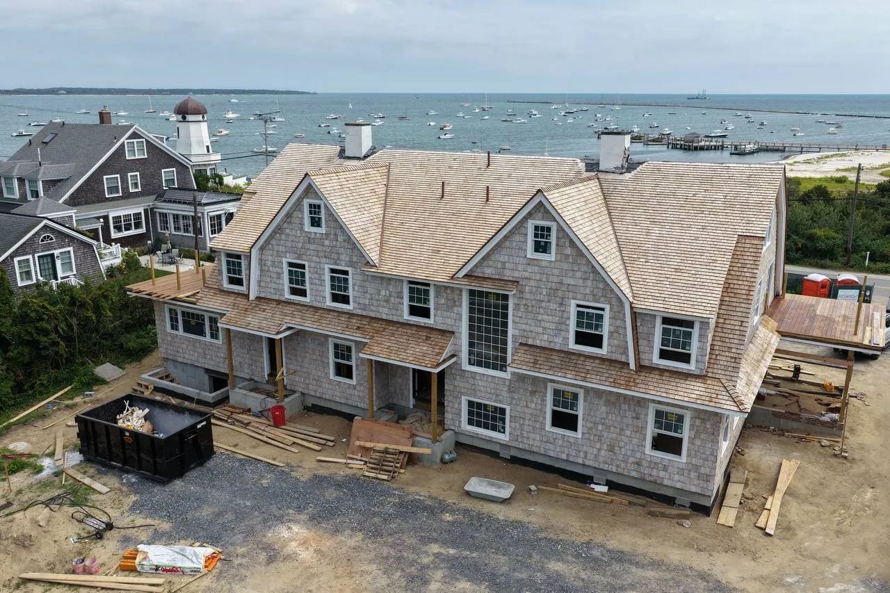 Red cedar sidewall shingles with crisp white window trim